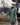 EQUIDRY women's thin fleece stowaway hood long waterproof horse riding coat in black forest green stood with horse