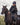 EQUIDRY women's long waterproof horse riding coat in black/olive modelled by rider out hacking, showing storm skirts and side zips