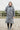 EQUIDRY Evolution Lux Women's Warm Waterproof Winter Horse Riding Coat Thick Fleece Lining with Faux Fur Trim Hood charcoal/pale pink modelled by rider in arena, full front view of coat