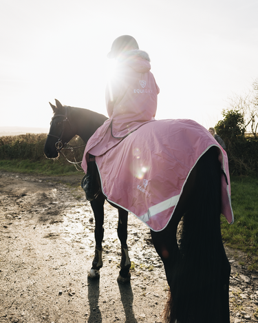 EQUIDRY Evolution Lux Women's Warm Waterproof Winter Horse Riding Coat Thick Fleece Lining with Faux Fur Trim Hood dusky pink on horse with exercise sheet 