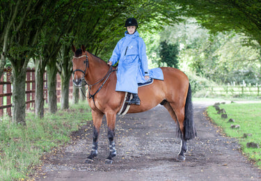 EQUIDRY women's thin fleece long waterproof horse riding coat in sky blue on horse