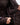 Close-up of a person adjusting the waistband of a dark brown jacket with 'EQUIDRY' branding.